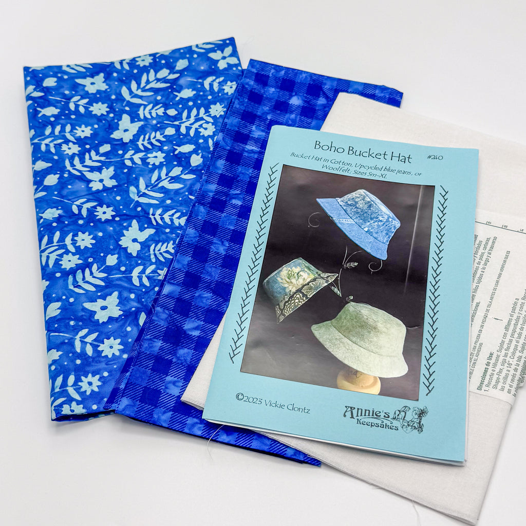 Blue patterned fabric with a sewing pattern featuring a boho bucket hat design.