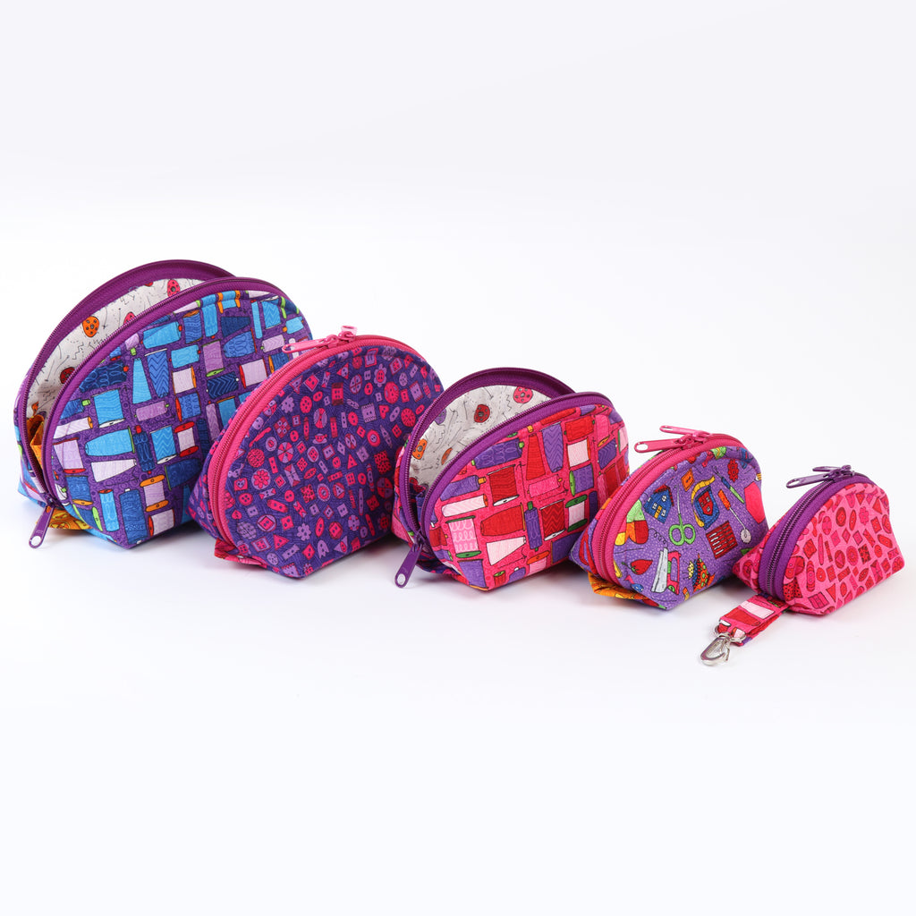 Set of colorful patterned zippered pouches on a white background