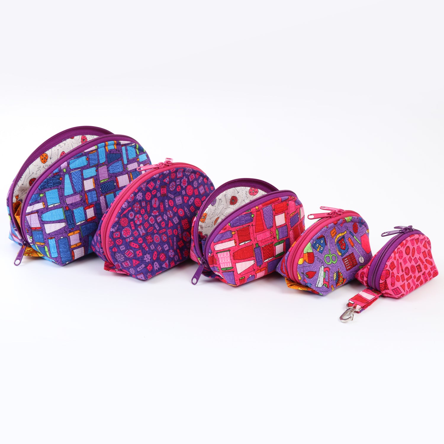 Set of colorful patterned zippered pouches on a white background