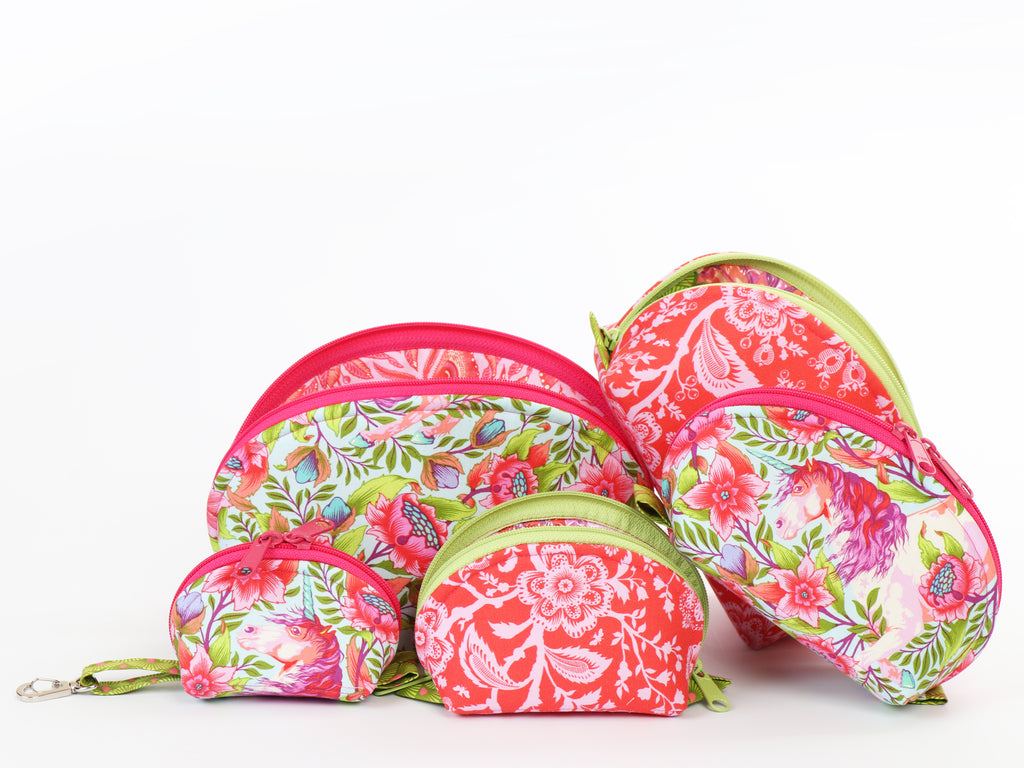Set of colorful floral-patterned fabric zippered pouches on a white background