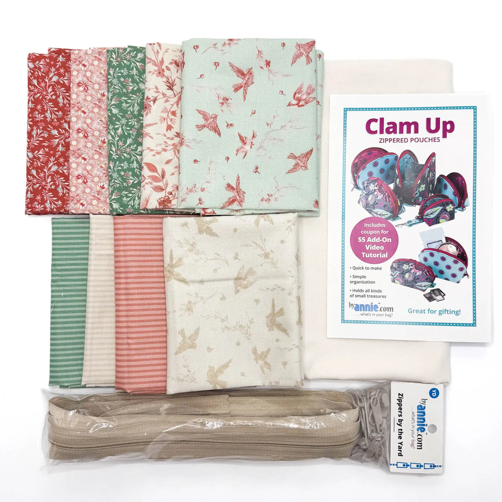 Collection of fat quarters with floral patterns, a zipper, and a 'Clam Up' sewing pattern on a white background.