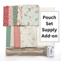 Set of fat quarters with floral patterns, a zipper, and fabric yardage, on a white background.