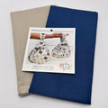 Fabric swatches in beige and blue with a sewing pattern featuring Japanese Knot Bag designs on a white background.