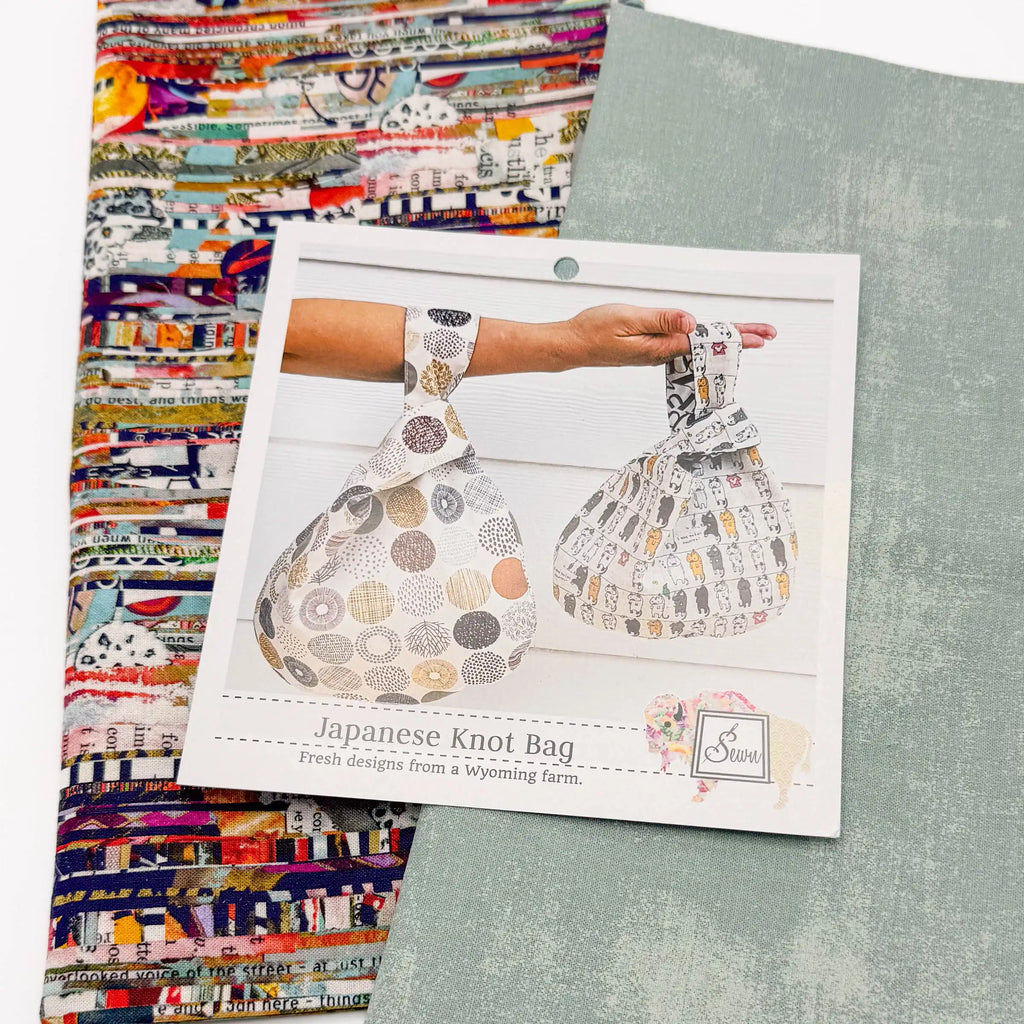 Japanese Knot Bag sewing pattern with two patterned fabrics on a white surface