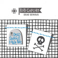 Kati Cupcake two multi-colored sewing labels, one that says Dead Serious I made this on a tombstone, and one that has a skull and cross bones. 