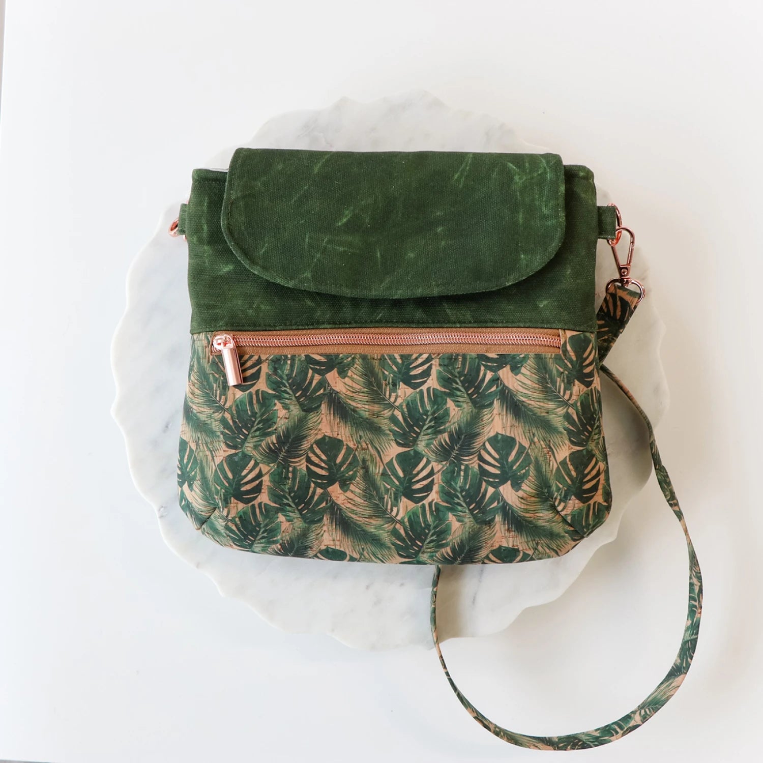 Green patterned handbag with a marble background
