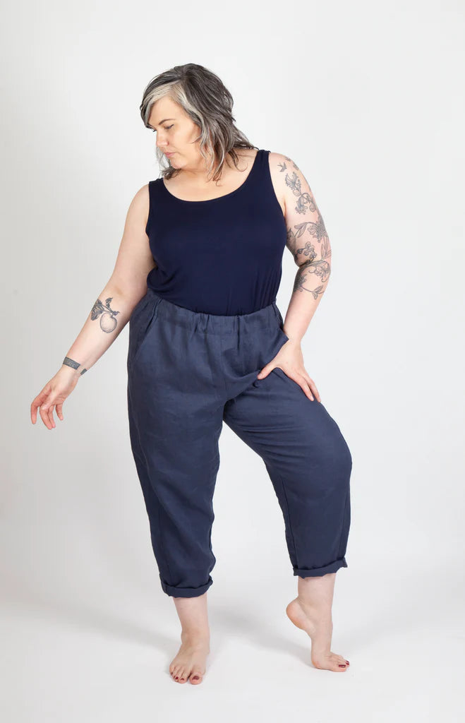 Person wearing a navy blue sleeveless top and Free Range Slacks on a white background