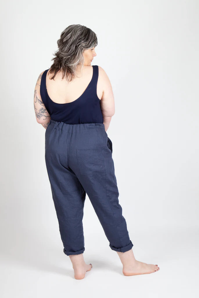 Person wearing a navy blue sleeveless top and Free Range Slacks on a white background