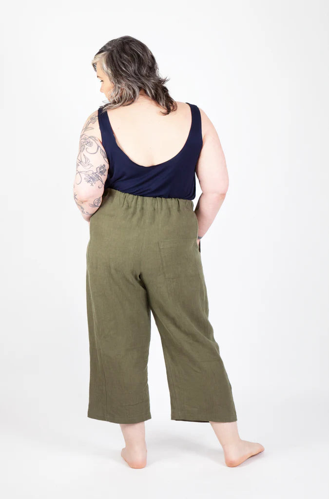 Person wearing green Free Range Slacks and a navy tank top on a white background