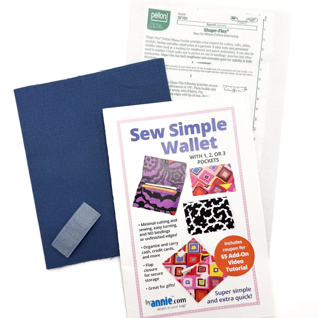 Sew Simple Wallet kit with blue fabric, pattern, interfacing, and hook and loop tape on a white background.